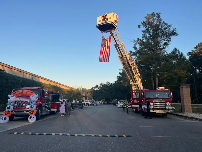 The aerial ladder flying an American flag over a community event