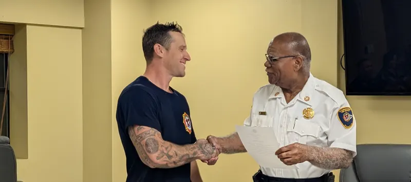 Chief Johnson shaking hands with newly promoted Captain Charlie Gruber