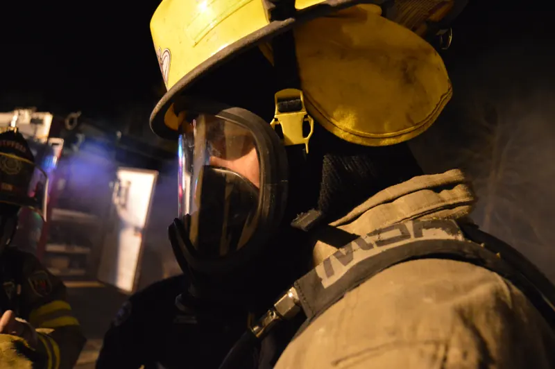 Firefighter in an SCBA mask during a training burn